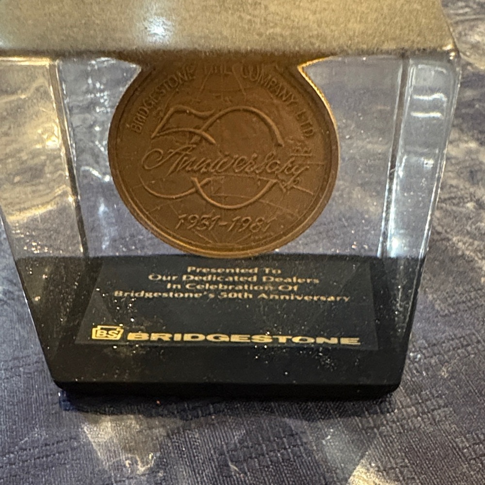 Bridgestone Tire 50th Anniversary Coin in Paperweight .
